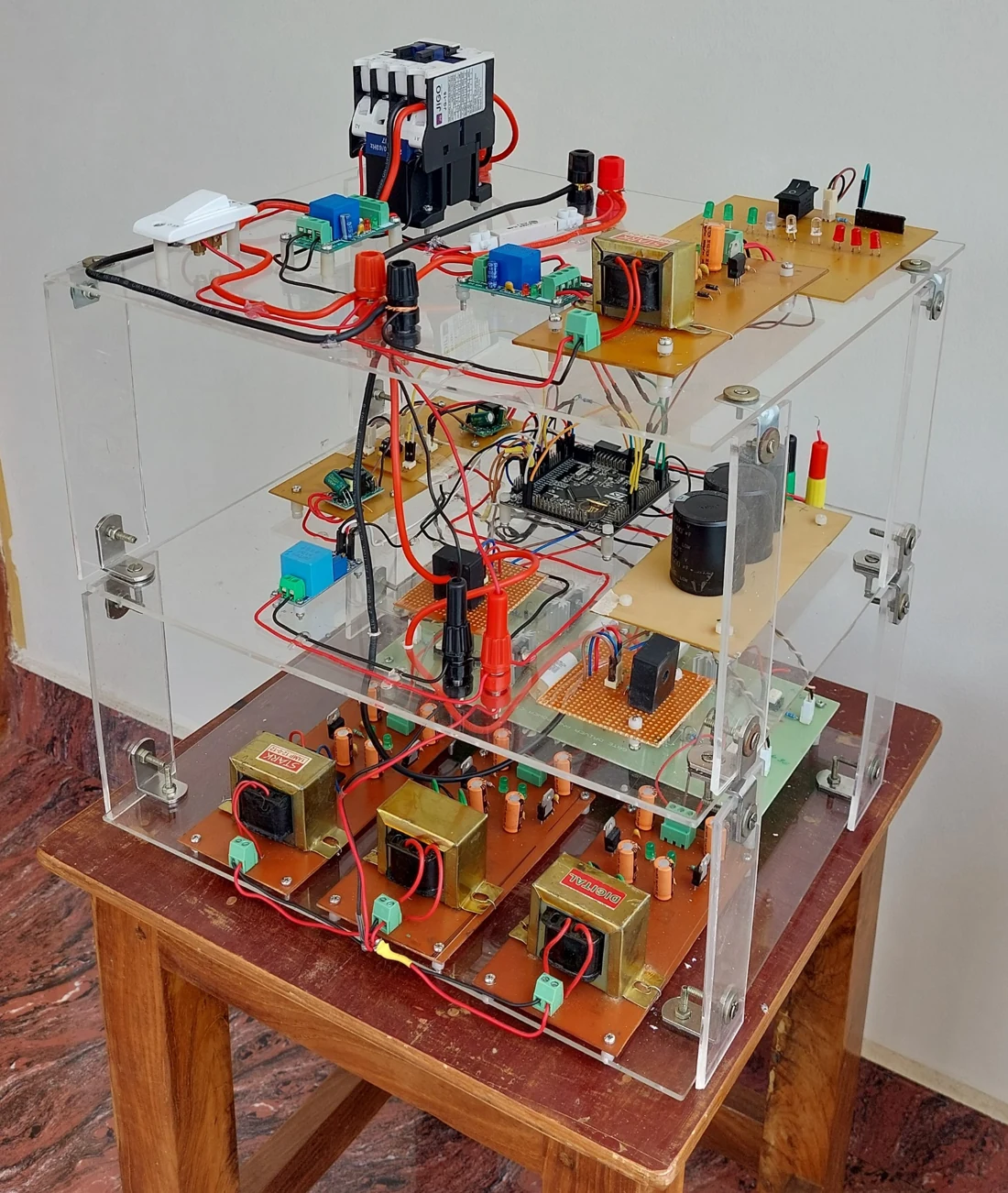 Single-phase D-STATCOM experimental hardware on a multi-level acrylic frame